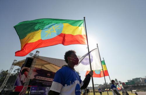 A volunteer holds an Ethiopian flag during a blood donation ceremony for the injured members of Ethiopia's National Defense Forces (ENDF) fighting against Tigray's special forces on the border between Amhara and Tigray, at the stadium in Addis Ababa, Ethiopia November 12, 2020. REUTERS/Tiksa Negeri
