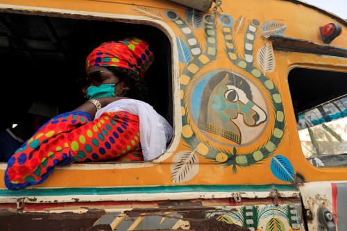 A passenger wearing a face mask sits on bus called "Car Rapide", amid the outbreak of the coronavirus disease (COVID-19), in Dakar, Senegal June 24, 2020. REUTERS/Zohra Bensemra     TPX IMAGES OF THE DAY