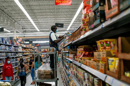 A worker and shoppers are seen wearing masks at a Walmart store, in North Brunswick, New Jersey, U.S. July 20, 2020. REUTERS/Eduardo Munoz