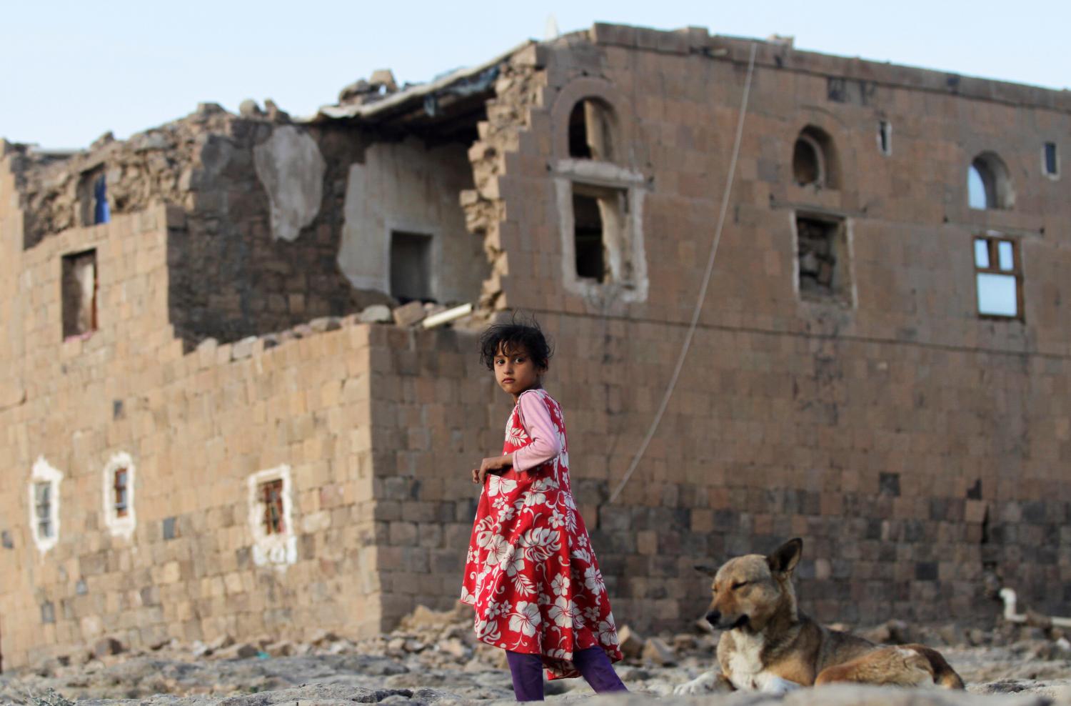 A girl walks near her house destroyed in an air strike carried out by the Saudi-led coalition in Faj Attan village, Sanaa, Yemen December 13, 2018.  REUTERS/Mohamed al-Sayaghi