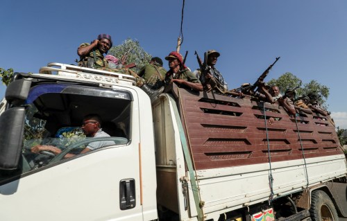 FILE PHOTO: Members of Amhara region militias ride on their truck as they head to face the Tigray People's Liberation Front (TPLF), in Sanja, Amhara region near a border with Tigray, Ethiopia November 9, 2020. REUTERS/Tiksa Negeri/File Photo