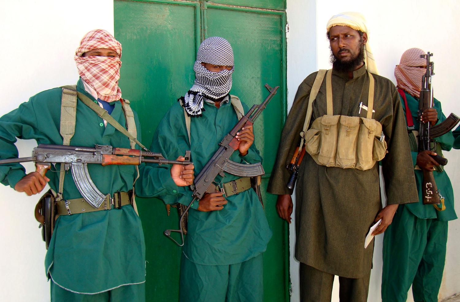 Sheik Muktar Robow Abu Mansur (2nd R), spokesman of Somalia's Islamic al-Shabab, leaves a news conference after vowing to step up attacks against government soldiers and foreign troops in Mogadishu December 14, 2008.  Somalia's President Abdullahi Yusuf sacked his prime minister on Sunday after they disagreed on a new cabinet demanded by donors, throwing his Western-backed interim government into disarray. Hassan Hussein Nur Adde was the second premier fired by Yusuf and had been in the job for only about a year. The fragile administration is fighting Islamist rebels who control the south and are camped on the outskirts of the capital Mogadishu.  REUTERS/Feisal Omar (SOMALIA)