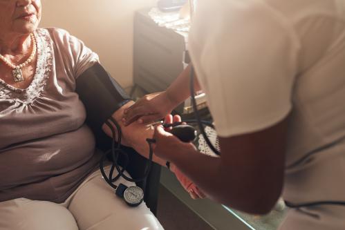 Healthcare worker taking bloodpressure of a patient