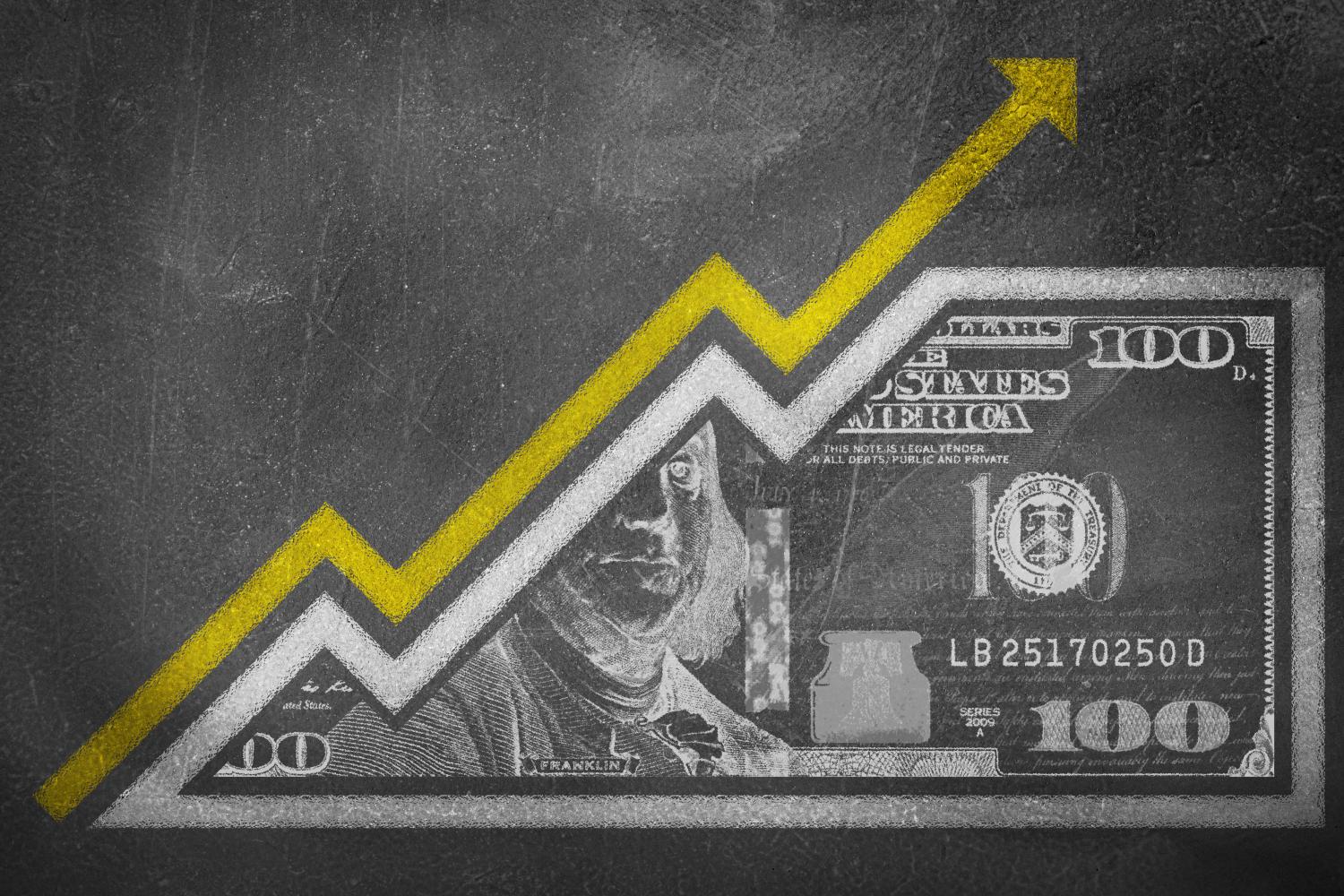 A money bill drawn on a chalk board looking like a growth graph with an upwards pointing arrow symbolizing economic relationships.