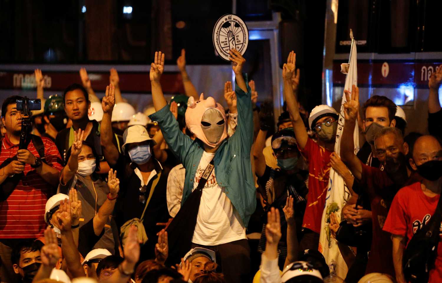 Pro-democracy demonstrators show the three-fingered salute during a protest outside the German Embassy, in Bangkok, Thailand October 26, 2020. REUTERS/Jorge Silva