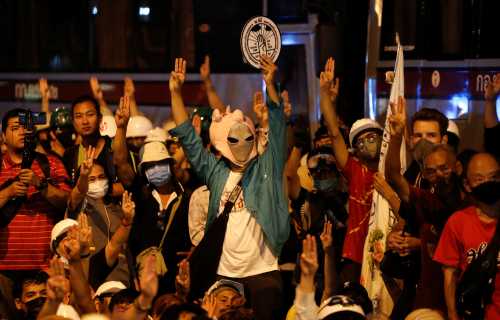 Pro-democracy demonstrators show the three-fingered salute during a protest outside the German Embassy, in Bangkok, Thailand October 26, 2020. REUTERS/Jorge Silva