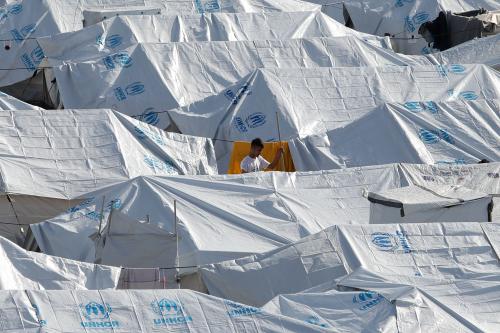 A young man stands among tents in the Kara Tepe camp for refugees and migrants on the island of Lesbos, Greece, October 14, 2020. REUTERS/Elias Marcou