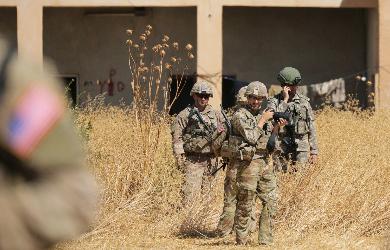 Turkish and American soldiers stand near a former YPG military point during a joint U.S.-Turkey patrol, near Tel Abyad, Syria September 8, 2019. REUTERS/Rodi Said