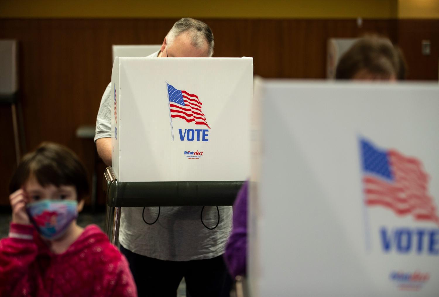 A voter casts his ballot at Mancini Hall in the Ocean County Library Tuesday. Board of Election workers helped residents who had never received or had problems with ballots mailed to them.         Toms River, NJTuesday, November 3, 2020Ocvote110320a