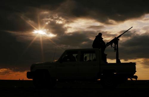 A fighter of Syrian Democratic Forces (SDF) sits on a vehicle near the village of Baghouz, Deir Al Zor province, Syria February 27, 2019. REUTERS/Rodi Said