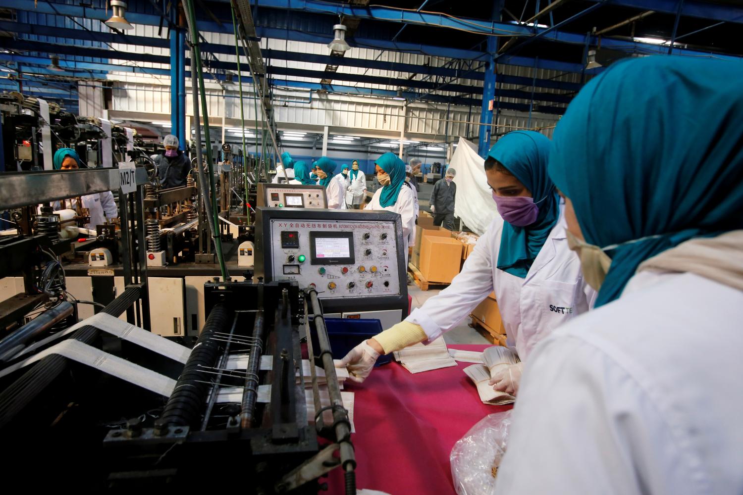 Employees collect protective face masks from the production line at a factory as Morocco starts to increase their production following an outbreak of the coronavirus disease (COVID-19), in Casablanca, Morocco April 10, 2020. REUTERS/Youssef Boudlal