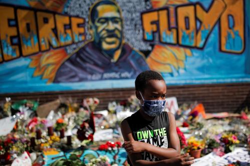 A child wears a protective mask at a makeshift memorial honoring George Floyd, at the spot where he was taken into custody, in Minneapolis, Minnesota, U.S., June 1, 2020.  REUTERS/Carlos Barria