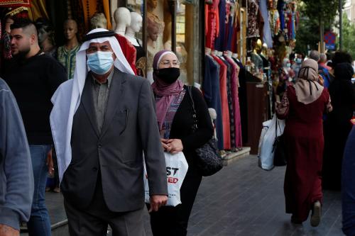 People, some wearing protective masks, walk in downtown Amman, amid fears over rising numbers of the coronavirus disease (COVID-19) cases, Jordan November 4, 2020. REUTERS/Muhammad Hamed