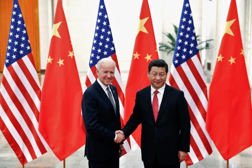 FILE PHOTO: Chinese President Xi Jinping shakes hands with U.S. Vice President Joe Biden (L) inside the Great Hall of the People in Beijing December 4, 2013. REUTERS/Lintao Zhang/Pool/File Photo