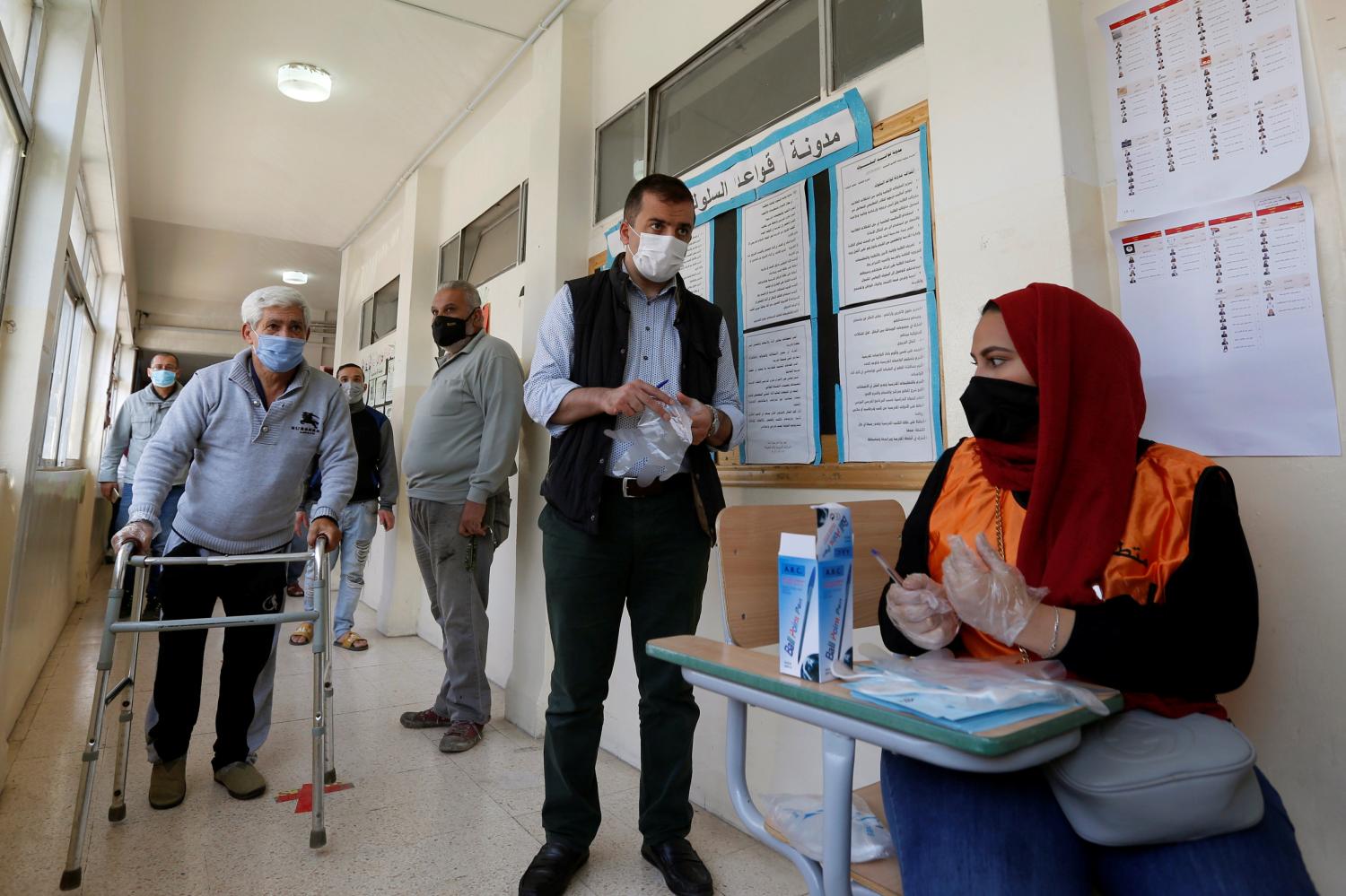 People wait to cast their votes during parliamentary elections, amid fears over rising number of the coronavirus disease (COVID-19) cases, in Amman, Jordan November 10, 2020. REUTERS/Muhammad Hamed