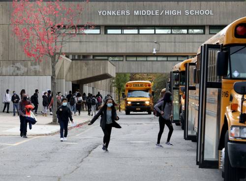 Students run toward their school busses after dismissal at Yonkers Middle High School, Oct. 27, 2020.Yonkers School Dismissal