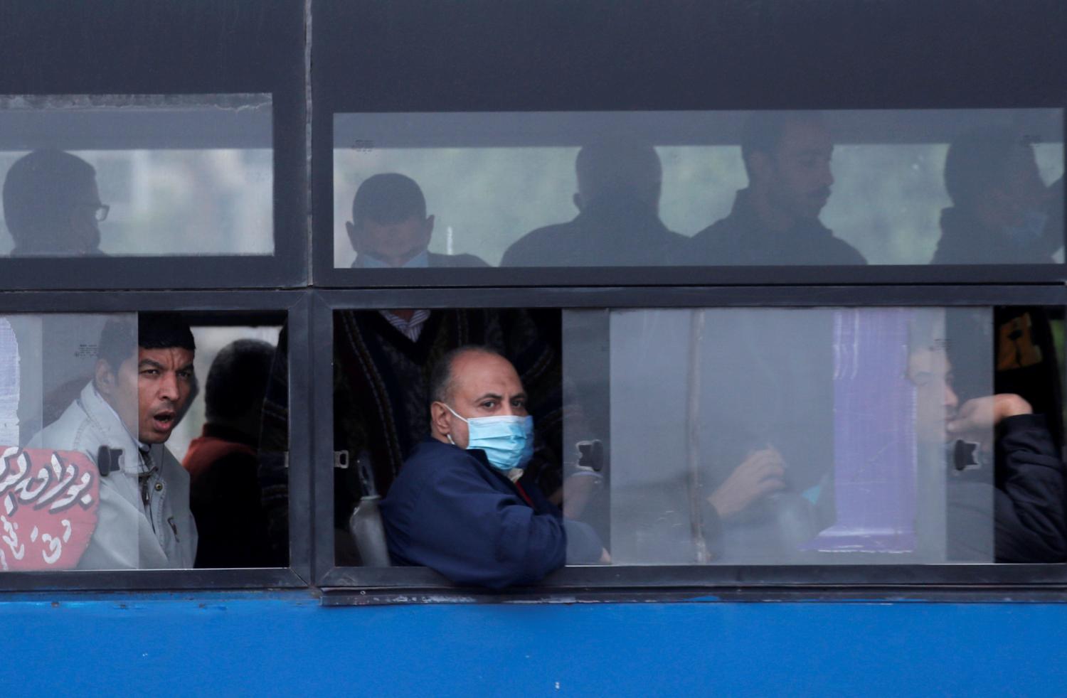 Egyptians, some of them wearing protective masks,  look from the bus windows amid the coronavirus disease (COVID-19) pandemic in Cairo, Egypt December 17, 2020. REUTERS/Amr Abdallah Dalsh