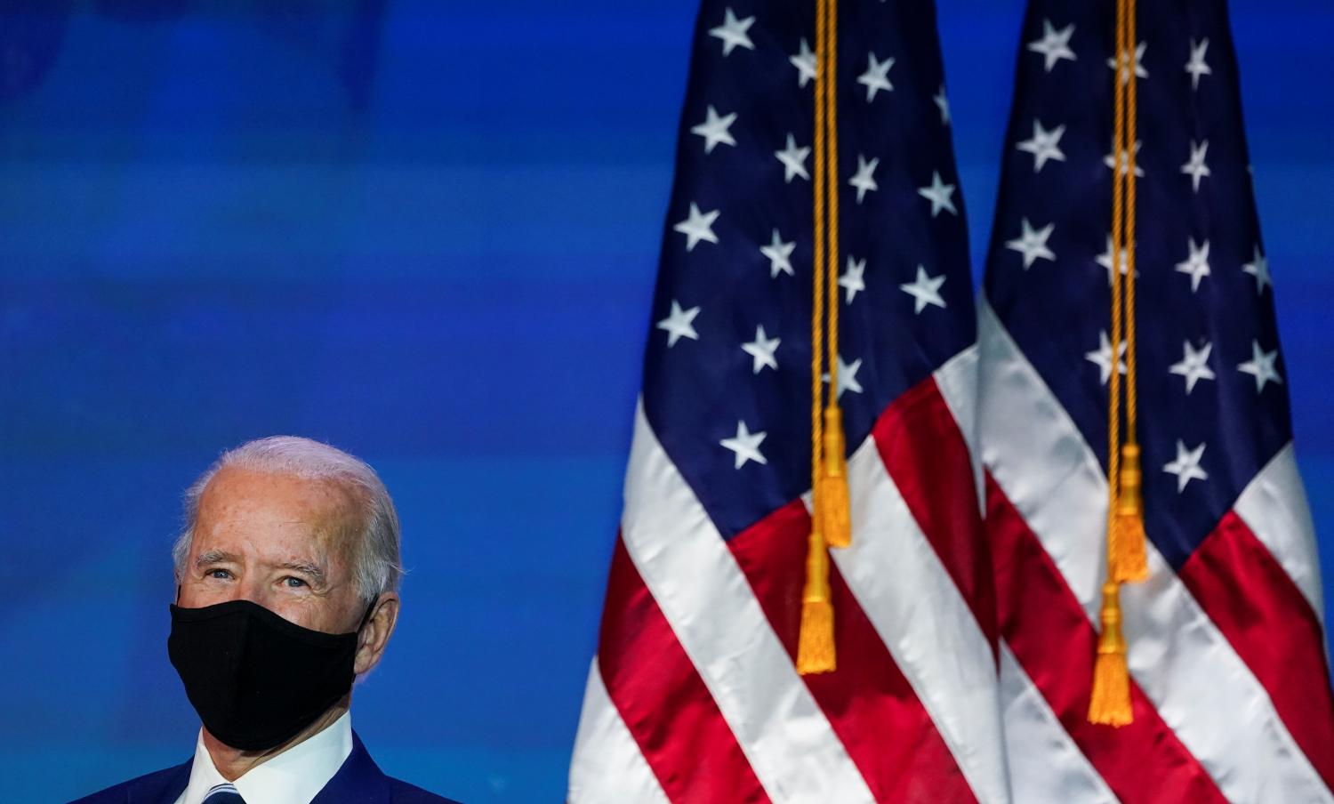 U.S. President-elect Joe Biden stands by after announcing retired U.S. General Lloyd Austin as his nominee to be defense secretary at his transition headquarters in Wilmington, Delaware, U.S., December 9, 2020. REUTERS/Kevin Lamarque