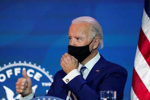 U.S. President-elect Joe Biden gestures to retired U.S. General Lloyd Austin speak after Biden announced Austin as his nominee to be defense secretary at his transition headquarters in Wilmington, Delaware, U.S., December 9, 2020. REUTERS/Kevin Lamarque