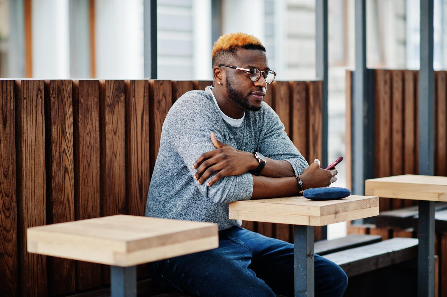 man sitting outside at table