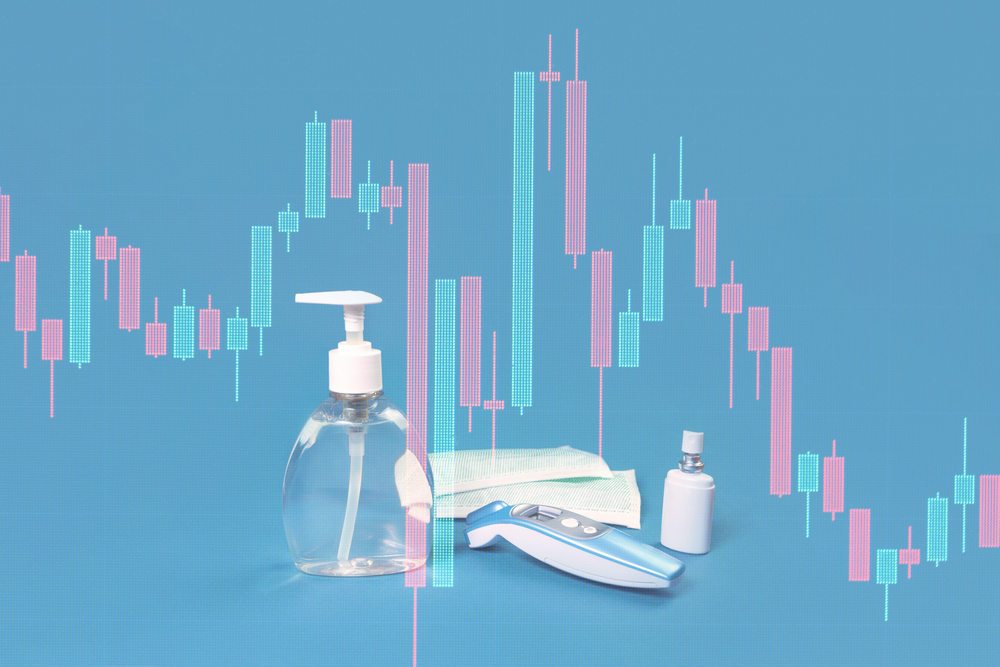 Stock market graph crash and hand sanitizer, flu mask, antibacterial soap and thermal scanner on blue. Personal hygiene and disinfection during viral pandemic and flu season financial markets response