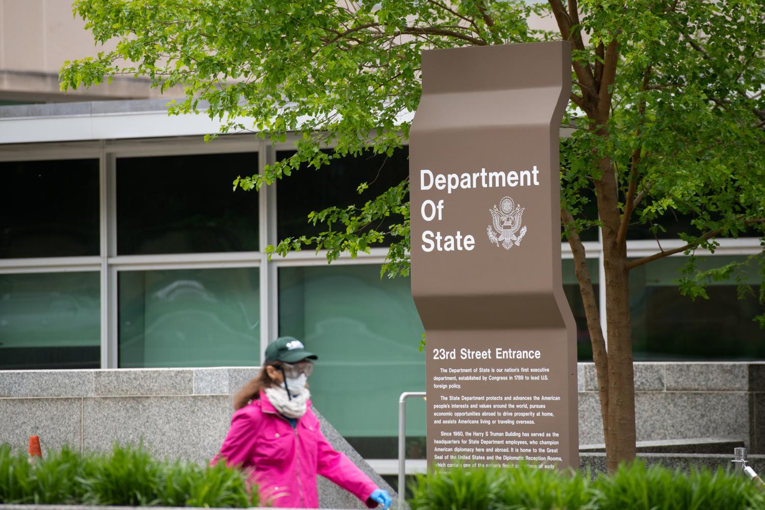 A pedestrian wearing gloves, goggles and a mask walks by the State Department in Washington, D.C. on April 23, 2020 amid the Coronavirus pandemic. After extended negotiations over an additional $500 billion in stimulus funding in response to the ongoing COVID-19 outbreak, the U.S. Congress is set send another economic relief bill to President Trump to sign into law after a House vote later today. (Graeme Sloan/Sipa USA)No Use UK. No Use Germany.