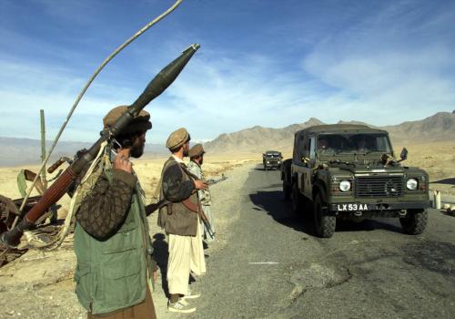 Afghan fighters monitor a convoy of British Army trucks carryingequipment from the Bagram airbase to Kabul December 31, 2001. TheBritish military transfered the equipment to the capital to prepare forthe headquarters of the International Security Assistance force, thepeacekeeping force authorised by the U.N Security Council to stabilizethe country following the Taliban's collapse. REUTERS/Erik de CastroEDC/DL