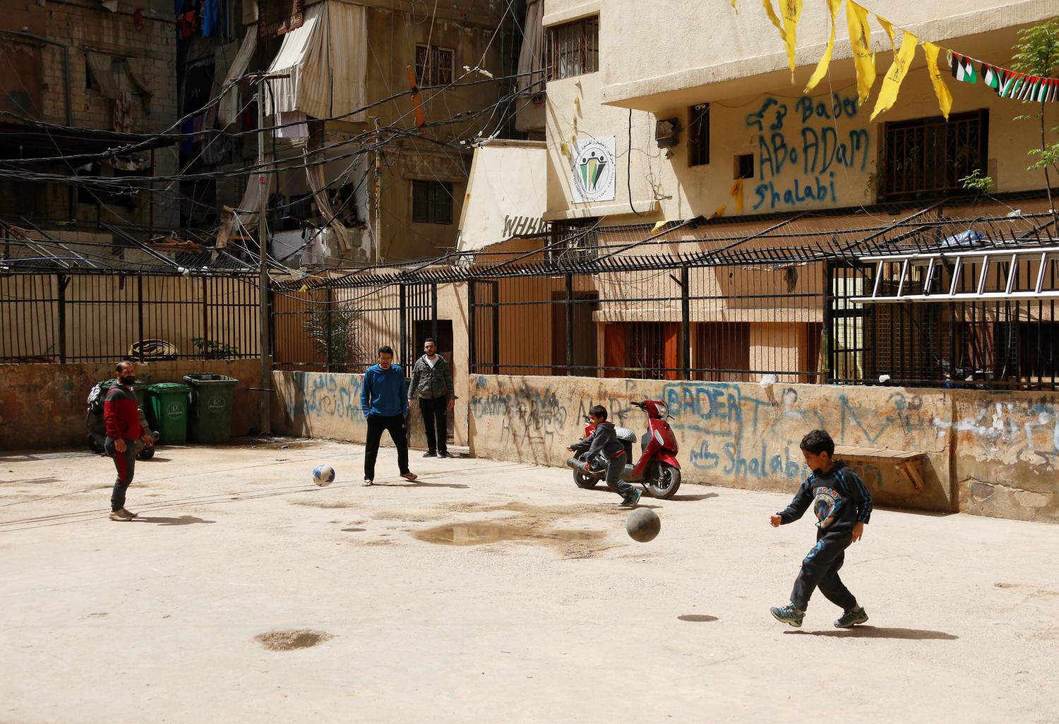 Boys play with balls in Shatila Palestinian refugee camp, as the spread of coronavirus disease (COVID-19) continues, in Beirut suburbs, Lebanon March 30, 2020. Picture taken March 30, 2020. REUTERS/Mohamed Azakir