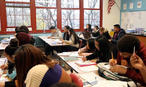 Catalina Chavez, center, an "English as a new language" teacher works with sophomore Vanessa Mejia, who came to the country two months ago from Guatemala, during Eartth Science class at Roosevelt High School - Early College Studies Nov. 7, 2019 in Yonkers. Fuad Alhomidi, a student from Yemen, works beside them.Secondary