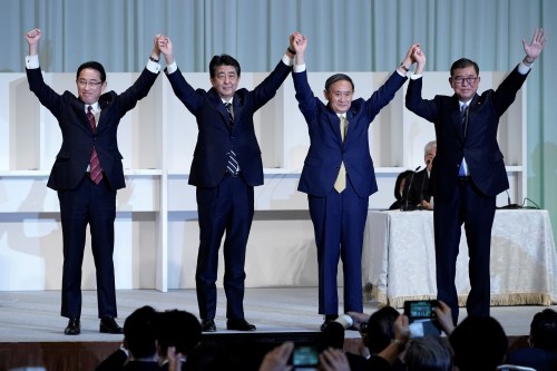 Japan's Prime Minister Shinzo Abe, Chief Cabinet Secretary Yoshihide Suga, former Defense Minister Shigeru Ishiba and former Foreign Minister Fumio Kishida celebrate after Suga was elected as new head of the ruling party at the Liberal Democratic Party's (LDP) leadership election in Tokyo, Japan September 14, 2020. Eugene Hoshiko/Pool via REUTERS
