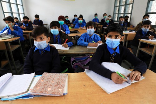 Students wear protective masks as they attend a class at school as the outbreak of the coronavirus disease (COVID-19) continues, in Peshawar, Pakistan November 23, 2020. REUTERS/Fayaz Aziz