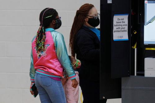 A voter casts her ballot in the run-off election featuring incumbent Republican U.S. Senators David Perdue and Kelly Loeffler and Democratic challengers Jon Ossoff and Raphael Warnock, at the polling site at the Dunbar Neighborhood Center in Atlanta, Georgia, U.S., January 5, 2021.   REUTERS/Brian Snyder