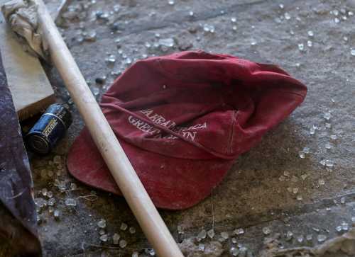 A "Make America Great Again" campaign cap sits in the debris left behind at the West Terrace entrance checkpoint of the U.S. Capitol a day after supporters of U.S. President Donald Trump stormed the Capitol in Washington, U.S., January 7, 2021. REUTERS/Erin Scott