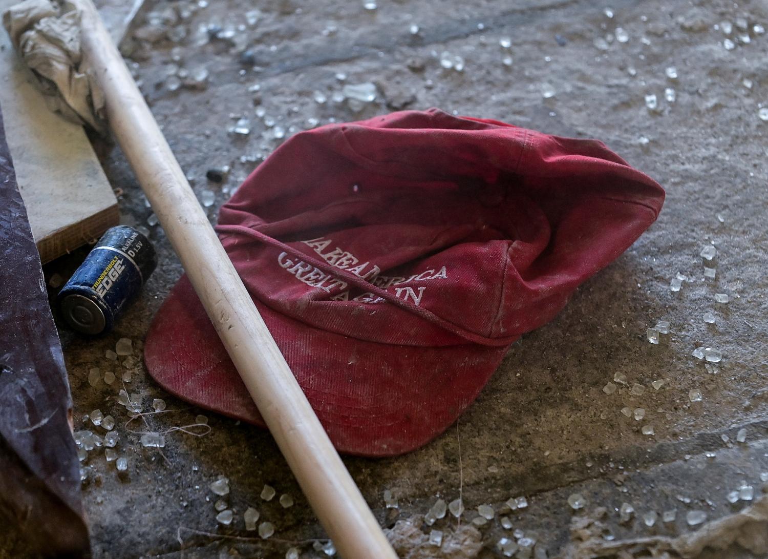 A "Make America Great Again" campaign cap sits in the debris left behind at the West Terrace entrance checkpoint of the U.S. Capitol a day after supporters of U.S. President Donald Trump stormed the Capitol in Washington, U.S., January 7, 2021. REUTERS/Erin Scott