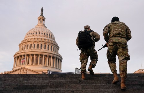 National Guard members walk at the Capitol, in Washington, U.S., January 15, 2021. REUTERS/Joshua Roberts     TPX IMAGES OF THE DAY