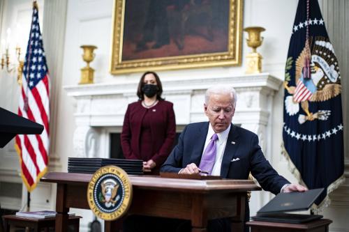 U.S. President Joe Biden signs an executive order after speaking during an event on his administration's Covid-19 response with U.S. Vice President Kamala Harris, left, in the State Dining Room of the White House in Washington, D.C., U.S., on Thursday, Jan. 21, 2021. Biden in his first full day in office plans to issue a sweeping set of executive orders to tackle the raging Covid-19 pandemic that will rapidly reverse or refashion many of his predecessor's most heavily criticized policies. Photo by Al Drago/Pool/ABACAPRESS.COM