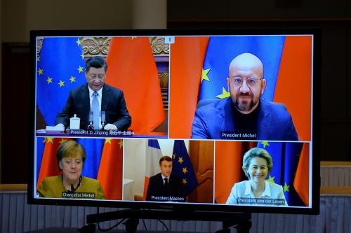 FILE PHOTO: European Commission President Ursula von der Leyen, European Council President Charles Michel, German Chancellor Angela Merkel, French President Emmanuel Macron and Chinese President Xi Jinping are seen on a screen during a video conference, in Brussels, Belgium December 30, 2020. REUTERS/Johanna Geron/Pool/File Photo