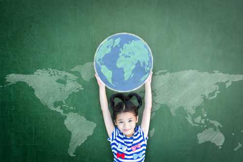 Girl holds a globe above her head.