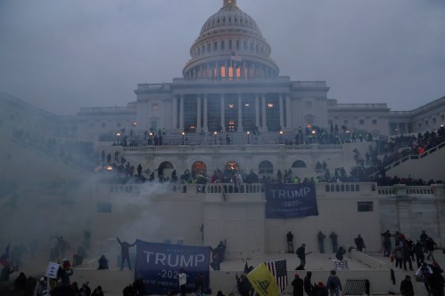 Police officers stand guard as supporters of U.S. President Donald Trump gather in front of the U.S. Capitol Building in Washington, U.S., January 6, 2021. REUTERS/Leah Millis     TPX IMAGES OF THE DAY