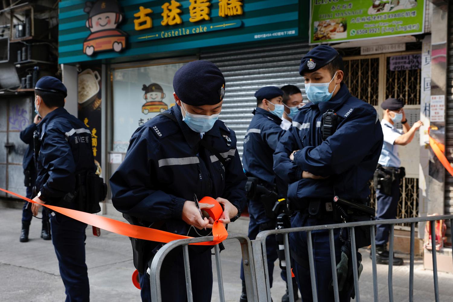 Police are seen outside the office of Daniel Wong Kwok-tung, a lawyer who tried to help the 12 people detained in mainland China, in Hong Kong, China January 14, 2021. REUTERS/Tyrone Siu
