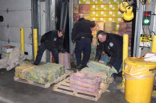 Law enforcement officers unload part of approximately 3,200 lbs. of cocaine, which was seized at the Port of New York/Newark on February 28, 2019 in a joint operation involving U.S. Customs and Border Protection (CBP), the U.S. Coast Guard (USCG), Homeland Security Investigations (HSI), the Drug Enforcement Administration (DEA), the New York Police Department (NYPD), and the New York State Police (NYSP), in Newark, New Jersey, U.S., in this image released on March 11, 2019.   Courtesy U.S. Customs and Border Protection/Handout via REUTERS   ATTENTION EDITORS - THIS IMAGE HAS BEEN SUPPLIED BY A THIRD PARTY.