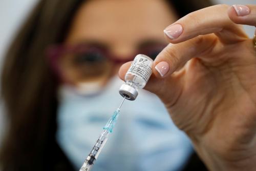 A medical worker holds up a coronavirus disease (COVID-19) vaccination vial as medical staff are vaccinated at Sheba Medical Center in Ramat Gan, Israel December 19, 2020. REUTERS/Amir Cohen