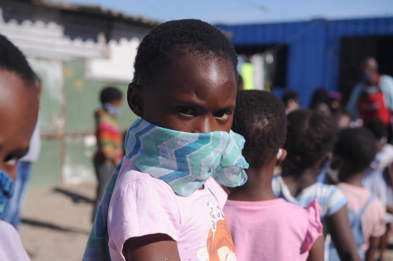 CAPE TOWN, SOUTH AFRICA- Children wait in line to eat amid the coronavirus crisis in Cape Town, South Africa on April 30, 2020. Entrepreneurs and foundations have teamed up to feed children in the area. Approximately 300 children are fed daily since the onset of the coronavirus quarantine. (NO RESALE)