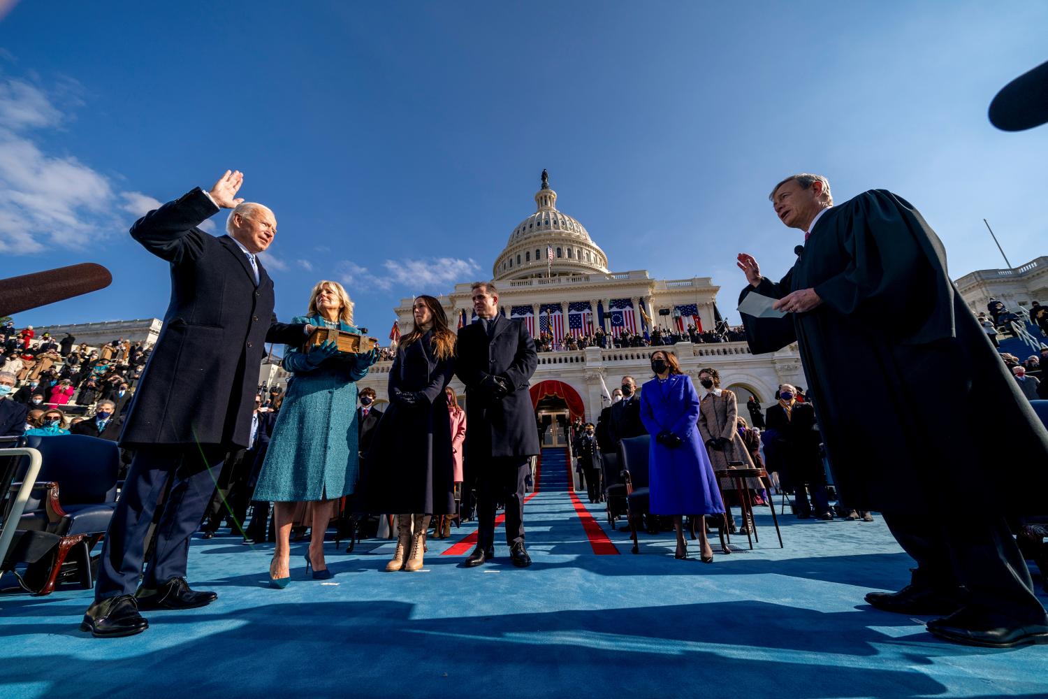 FILE PHOTO: Joe Biden is sworn in as the 46th president of the United States by Chief Justice John Roberts as Jill Biden holds the Bible during the 59th Presidential Inauguration at the U.S. Capitol, in Washington, U.S., January 20, 2021. Andrew Harnik/Pool via REUTERS/File Photo