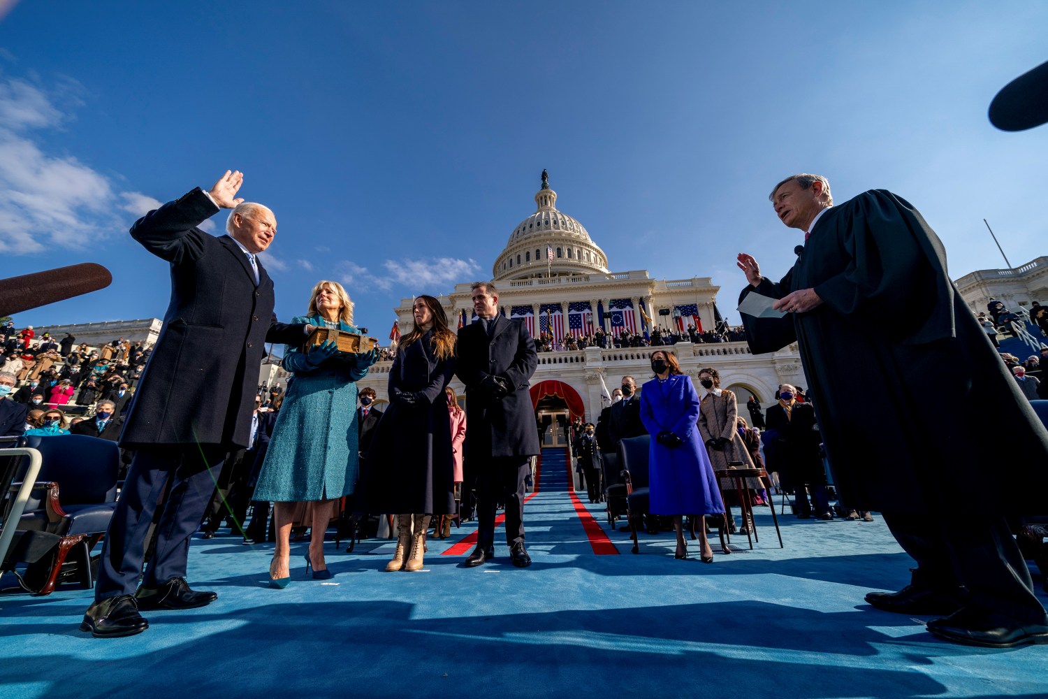 FILE PHOTO: Joe Biden is sworn in as the 46th president of the United States by Chief Justice John Roberts as Jill Biden holds the Bible during the 59th Presidential Inauguration at the U.S. Capitol, in Washington, U.S., January 20, 2021. Andrew Harnik/Pool via REUTERS/File Photo