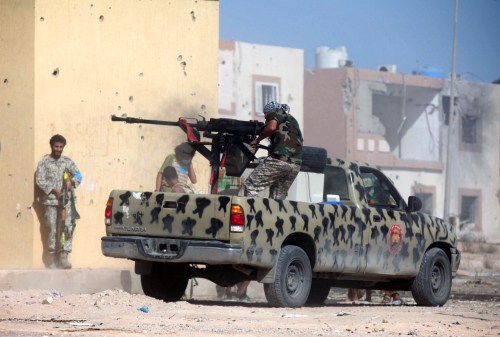 A member of Libyan forces allied with the U.N.-backed government fires a weapon on a pickup truck during a battle with Islamic State militants in Giza Bahreya, in Sirte, Libya October 27, 2016. REUTERS/Hani Amara