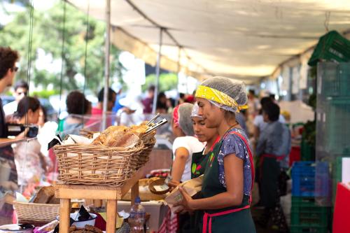 Lima, Peru - February 16 2019: Female worker at bakery selling bread at street market called bioferia in parque reducto, Miraflores