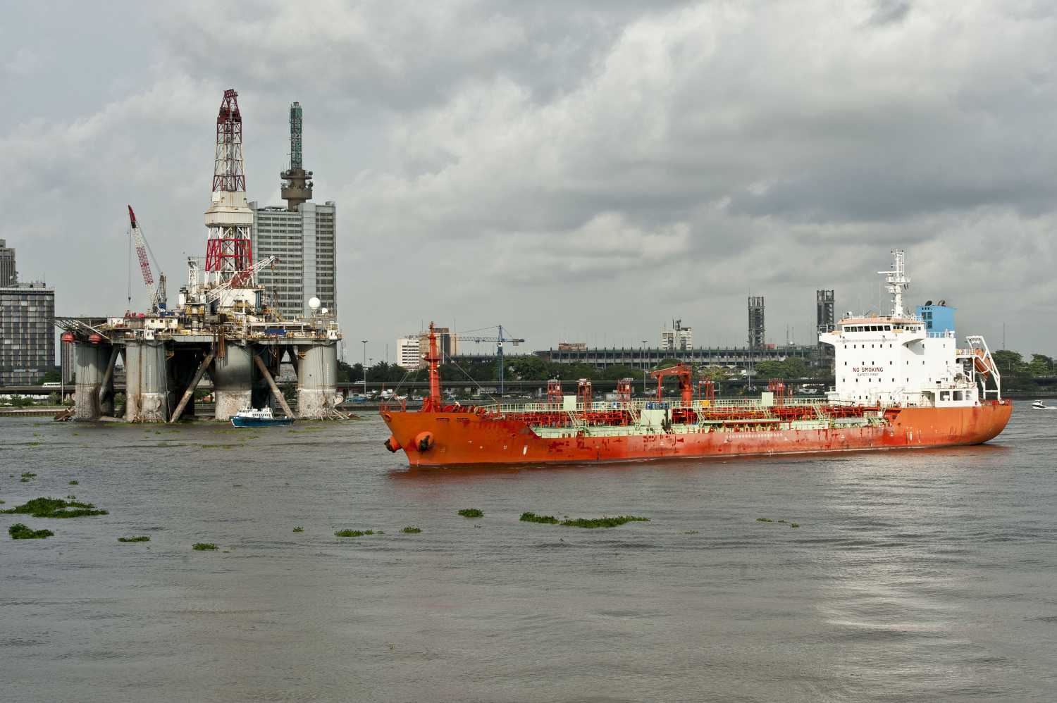 Ship with oil rig in the background in the Nigerian capitol Lagos