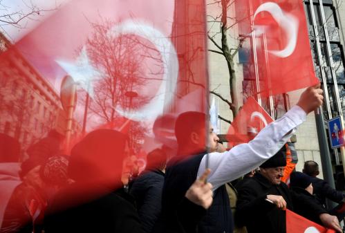 Supporters of Turkish President Tayyip Erdogan wave national flags ahead of a meeting of the president with NATO Secretary General Jens Stoltenberg, in Brussels, Belgium March 9, 2020. REUTERS/Johanna Geron