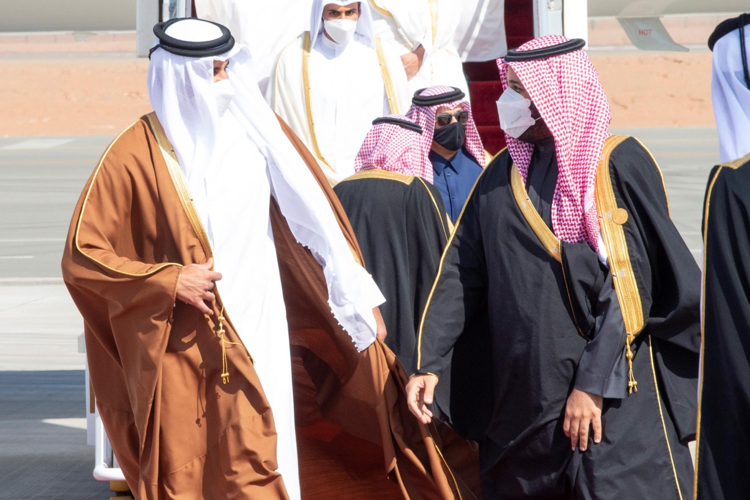 Saudi Crown Prince Mohammed bin Salman (R) welcomes Emir of Qatar Sheikh Tamim bin Hamad bin Khalifa Al-Thani upon his arrival in the city of alUla ahead of the 41st Gulf Cooperation Council (GCC) summit.